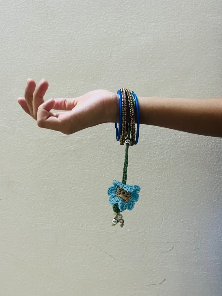 Blue handmade crochet lumba hanging from bangles