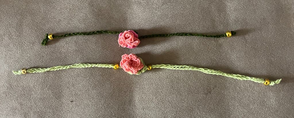 Pair of pink handmade crochet rose rakhis